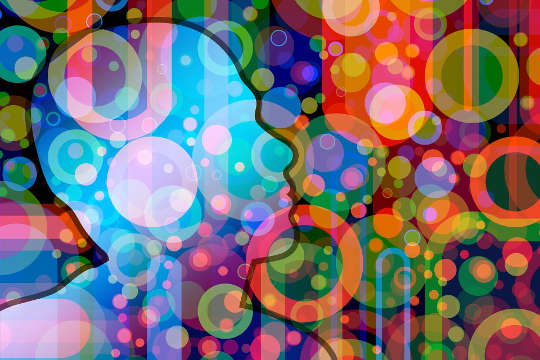 an outline of a human head with numerous circles of various colors and light around it